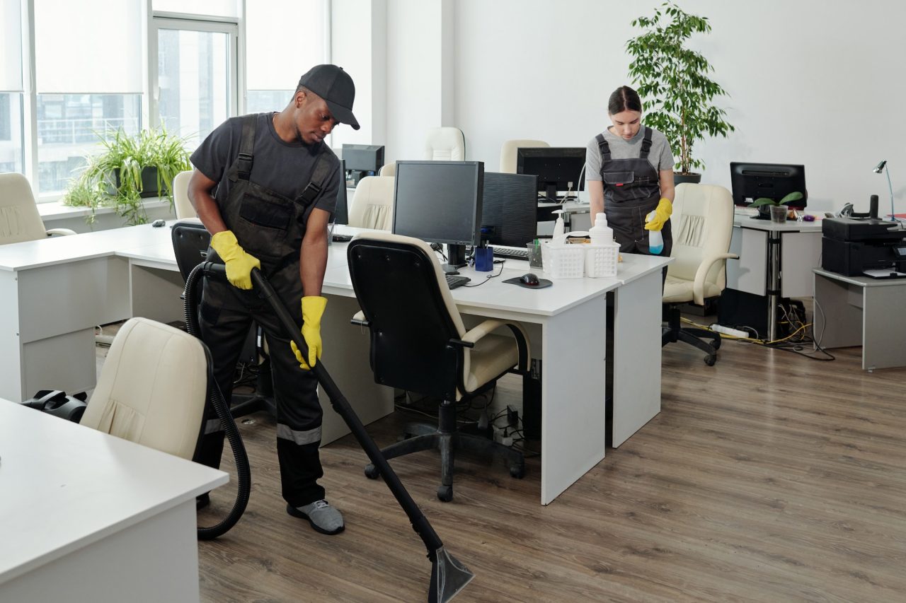 workers-of-cleaning-service-company-carrying-out-their-work-in-openspace-office